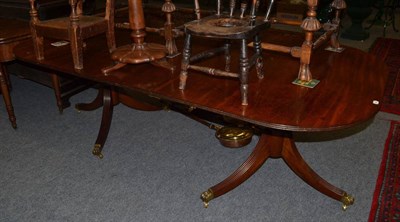 Lot 1491 - A George III mahogany twin pedestal dining table fitted one additional leaf