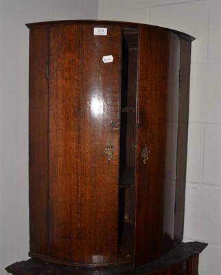 Lot 1516 - An early 19th century oak corner cupboard and a small oak gate leg table