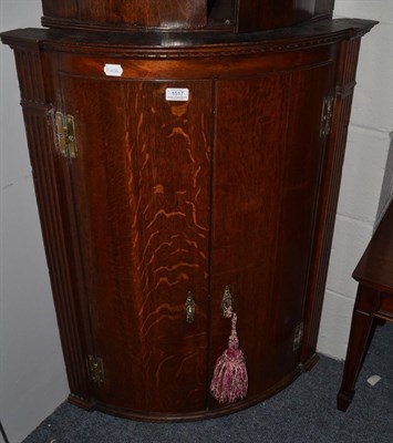 Lot 1517 - George III oak bowfront corner cabinet