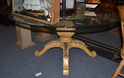 Lot 1552 - A cream and silver painted circular glass topped table with bulbous stem