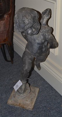 Lot 1578 - A lead water feature, probably 19th century, modelled as a putto gazing to the left with a...