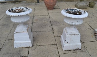 Lot 1591 - Pair of Victorian cast iron garden urns on plinth bases