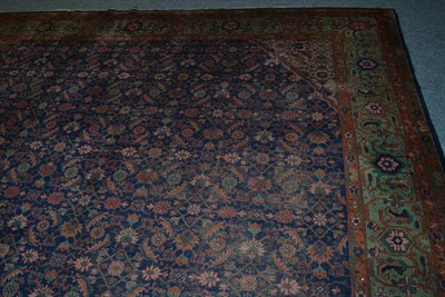 Lot 1611 - An antique Indian carpet of square form, the indigo Herati field framed by spandrels and ivory...