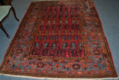 Lot 1613 - Unusual Malayir rug, West Persia, the raspberry field with rows of serrated leaves enclosed by...