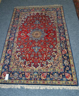 Lot 1618 - Isfahan rug, Central Persia, the blood red floral vine field centred by a sky blue pole...