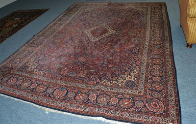 Lot 1624 - Kashan carpet, Central Persia, circa 1925, the madder field of scrolling vines centred by a stepped