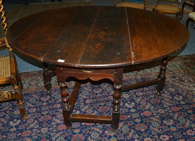 Lot 1636 - * An early 18th century six seater gate leg table fitted a frieze drawer