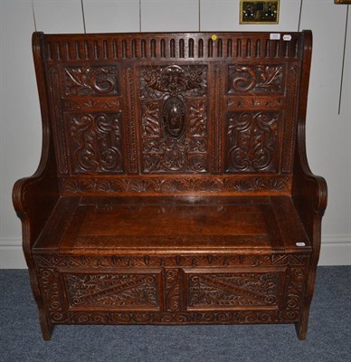 Lot 1643 - * Victorian carved oak settle with hinged seat