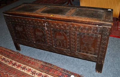 Lot 1652 - * A 17th century joined oak chest with hinged lid and carved stiles and muntins