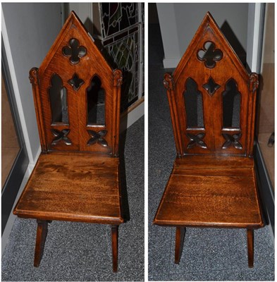 Lot 1660 - A pair of Gothic revival oak hall chairs