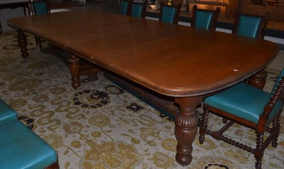 Lot 1666 - An impressive Victoria oak extending dining table with eight additional leaves, raised on...