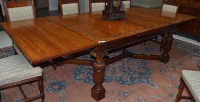 Lot 1672 - An oak draw leaf dining table on heavily turned and carved legs and heavy plain stretchers,...