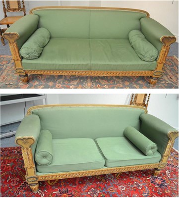 Lot 1701 - A pair of cream painted settees upholstered in green fabric