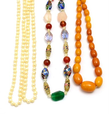 Lot 33 - # A cultured pearl necklace, length 128cm, an amber necklace, length 38cm, and a multi-glass...