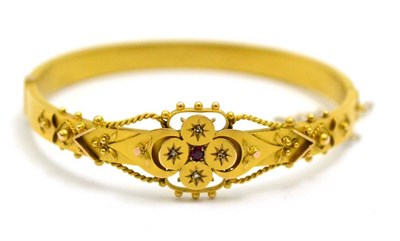 Lot 43 - # A 9ct gold Victorian ruby and diamond bangle, the ornate ropework decorated and beaded front...