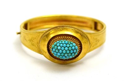 Lot 45 - # A Victorian bangle, with a cluster of cabochon turquoise to the centre, rope twist and...