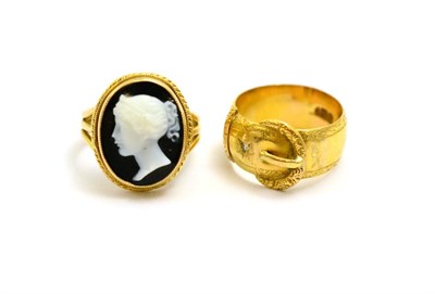 Lot 51 - # A hardstone cameo ring on a three row shank, finger size L and an 18ct gold buckle ring,...