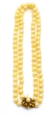 Lot 58 - # A two row cultured pearl necklace with yellow flower clasp, length of shorter strand 40.5cm