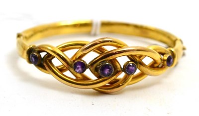 Lot 74 - # An amethyst knot bangle, the entwined front section section with five round cut stones, hinged to