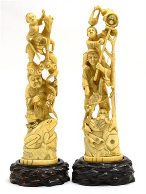 Lot 124 - A pair of late 19th century carved ivory figure groups on hardwood stands, height 36cm