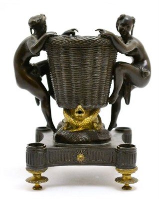 Lot 126 - A bronze and parcel gilt urn/centre piece surmounted by two nude females, raised on gilt...
