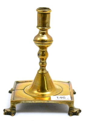 Lot 146 - A late 17th/18th century brass candlestick, probably Spanish, the knopped stem raised on a...