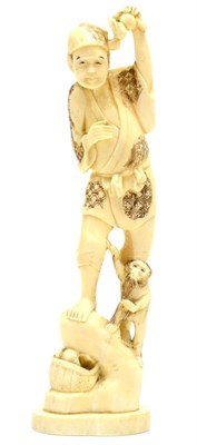 Lot 157 - A Japanese Meiji period ivory okimono of a figure and monkey, height 25cm
