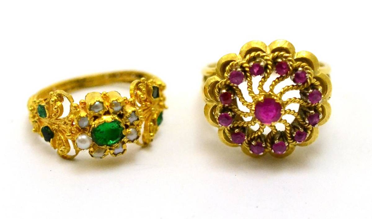 Lot 243 - # A ruby cluster ring, a swirl cluster inset with round cut rubies in yellow claw settings, on...