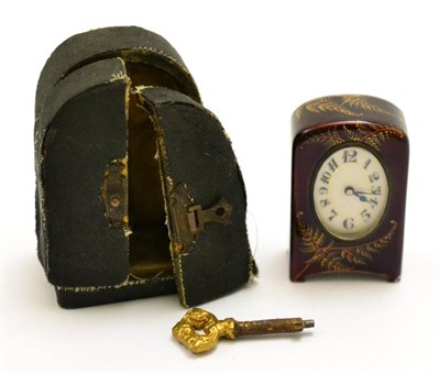 Lot 253 - A miniature enamel timepiece, signed Zenith, circa 1910, the dark red enamel case with painted...