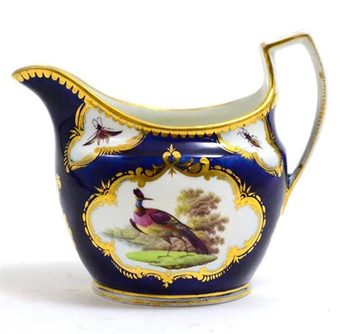 Lot 290 - A blue and gilt decorated cream jug with painted reserve depicting fancy birds, circa 1800