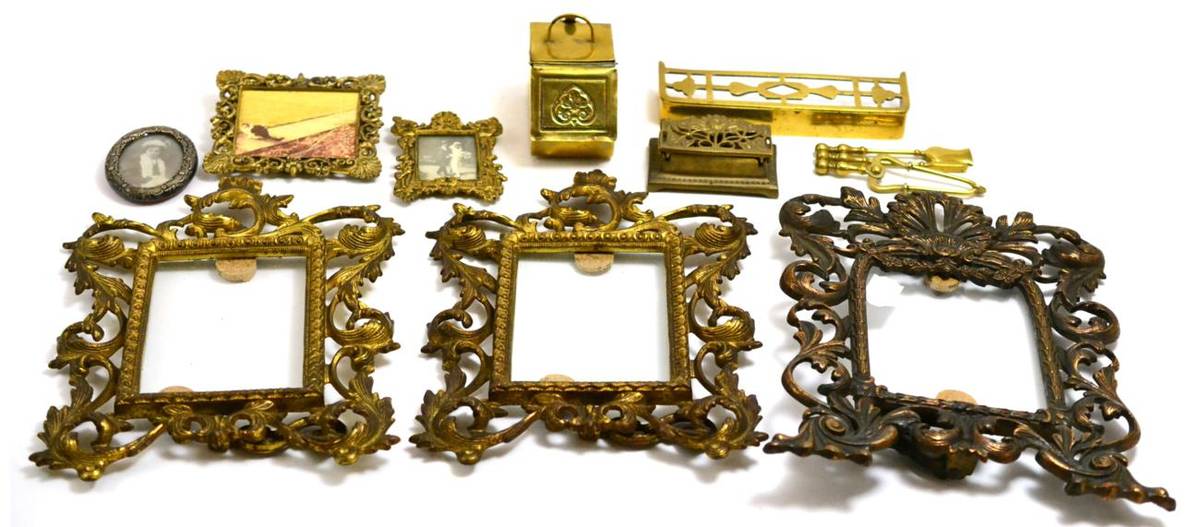 Lot 298 - A collection of brass miniature fire irons, coal scuttle, two miniature frames, a silver frame,...