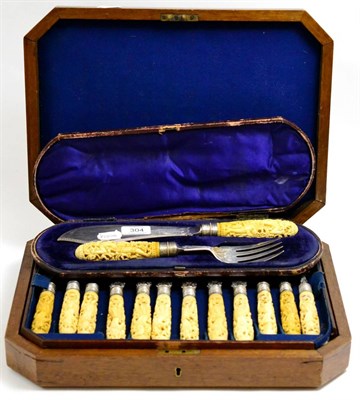 Lot 304 - A set of twelve late Victorian fish knives and forks with silver blades and carved ivory handles in
