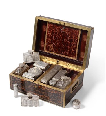 Lot 324 - A 19th century Coromandel vanity box with cut glass bottles and silver topped, engraved with a...
