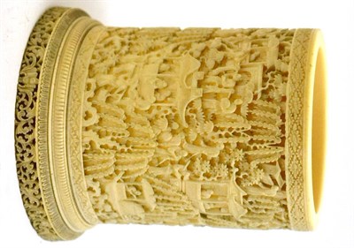 Lot 328 - A late 19th century carved ivory vase formed from a tusk carved overall with figures in a landscape