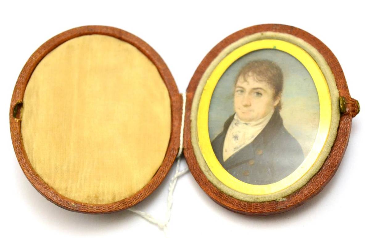 Lot 330 - An early 19th century oval portrait miniature of a gentleman, fitted in a leather case with a...