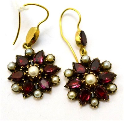 Lot 342 - # A pair of foil backed garnet and split pearl floral cluster drop earrings, with hook...