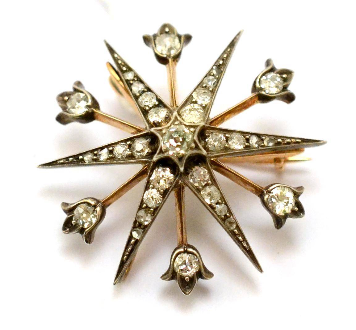 Lot 373 - # A Victorian diamond star brooch, six radial arms alternate with knife edge wires with a...