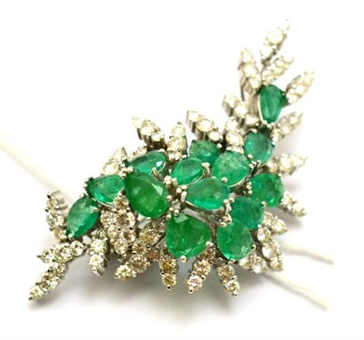 Lot 379 - An emerald and diamond pendant/brooch, in a spray form, set with pear cut emeralds and trios of...