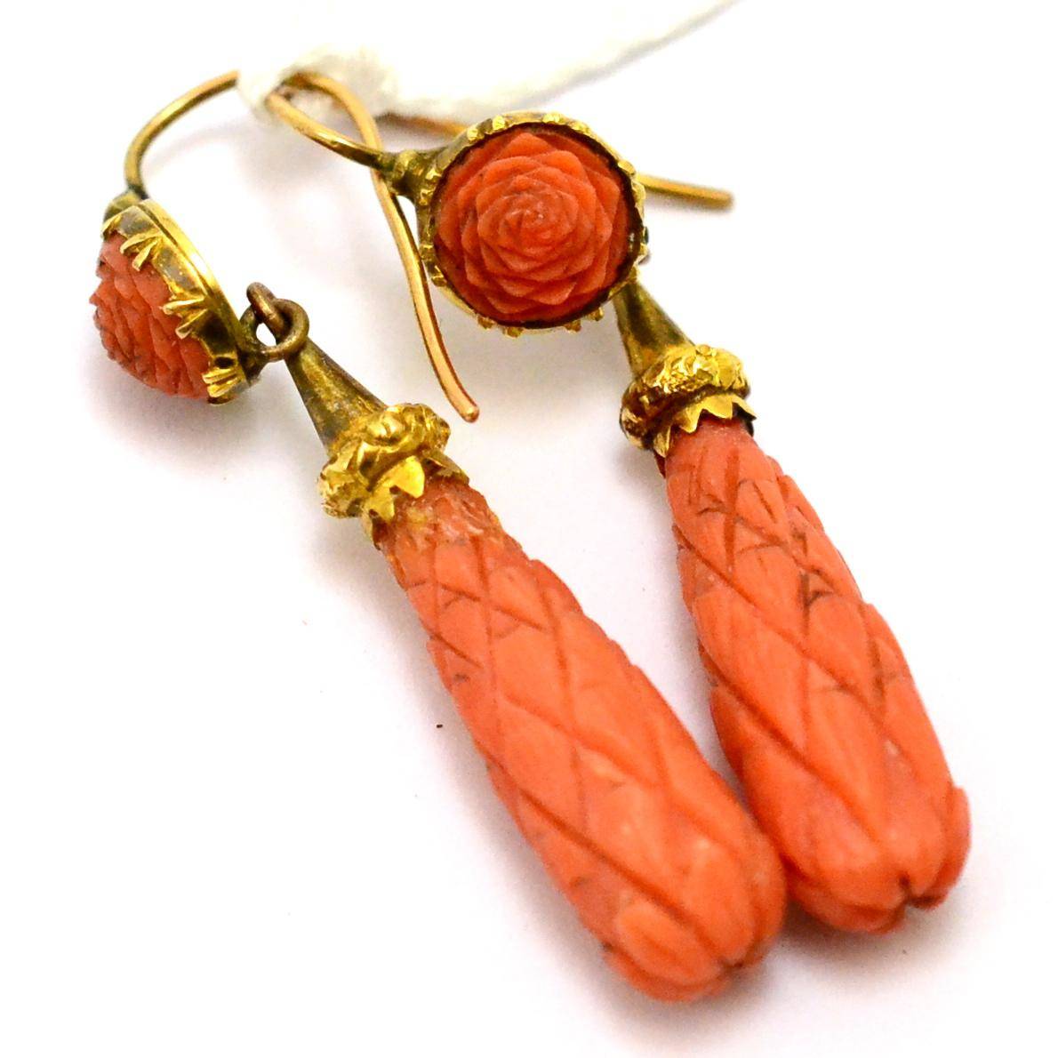 Lot 384 - A pair of coral drop earrings, carved as a rose suspending a carved drop, with later hook fittings