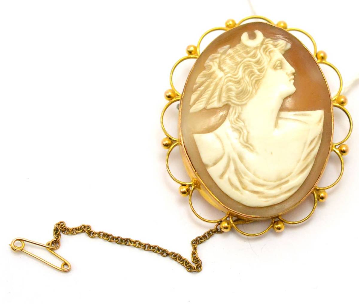 Lot 385 - A cameo brooch, the oval shell carved to depict Diana the Huntress, in a scalloped edge and...