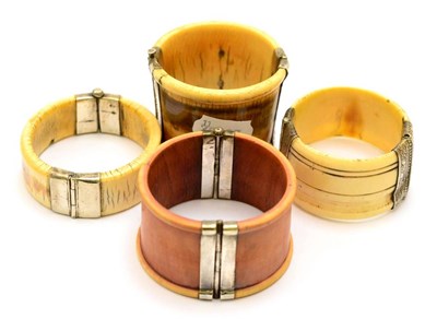 Lot 394 - A group of four Rajasthan silver mounted ivory bangles, circa 1900