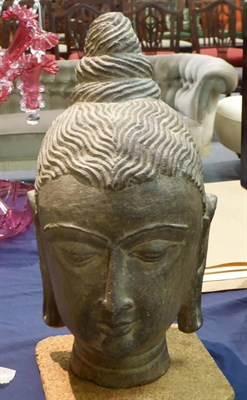 Lot 424 - An Indian carved stone head, height 40 cm
