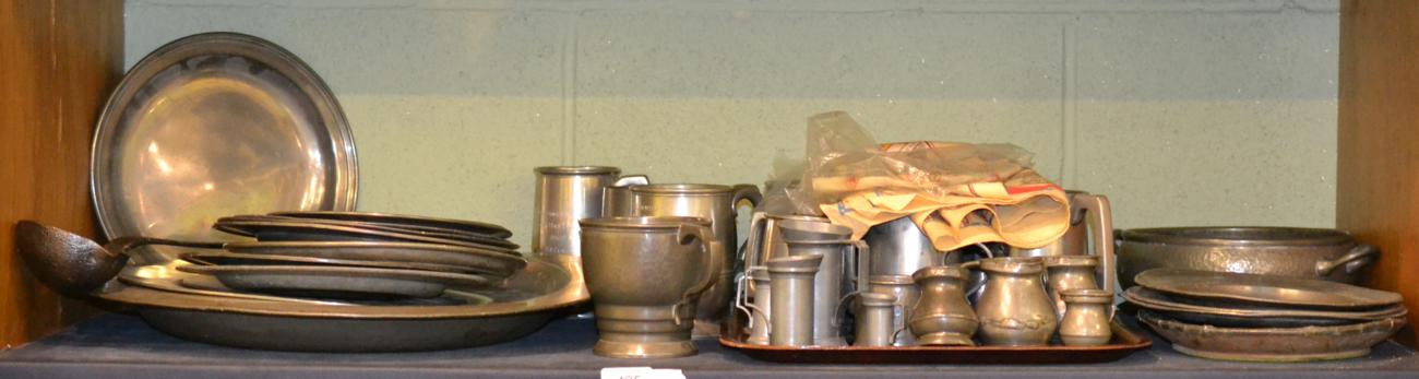 Lot 425 - Shelf of assorted pewter including 18th/19th century dinner plates, a large charger, 20th...
