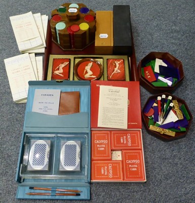 Lot 430 - Gaming items comprising: set of 1930s chips in wooden stand, two boxed sets of dominoes,...