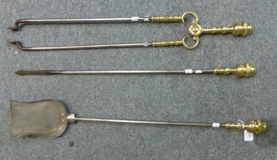 Lot 434 - A set of three brass fire irons comprising shovel, fire tongs and poker