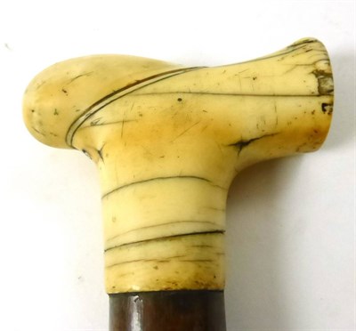 Lot 437 - A walking stick with whale tooth handle, dated 1682  Provenance: By repute, Smailes Shipping...