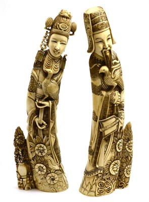 Lot 453 - A pair of Japanese ivory tusk carvings, circa 1950-60, as deities, each in long robes holding a...