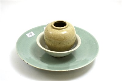 Lot 465 - A Chinese celadon glazed dish with carved decoration, two celadon glazed bowls and a vase (4)