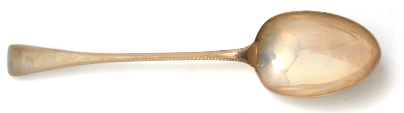 Lot 496 - Silver serving spoon, engraved with a family crest, Sheffield Assay