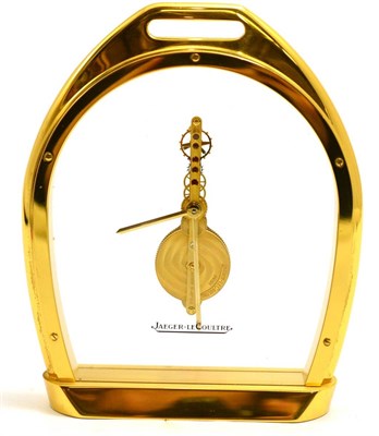 Lot 501 - A brass stirrup shaped mantel timepiece, signed Jaeger LeCoultre, 20th century, glazed panels...